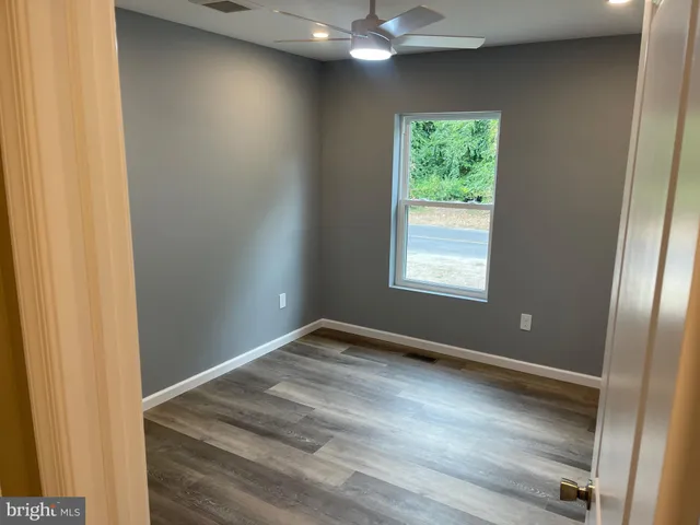 an empty room with wooden floor and closet