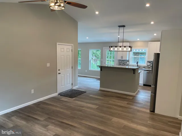 a kitchen with stainless steel appliances granite countertop a sink stove and wooden floor