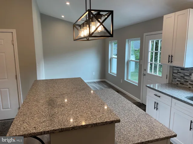 a living room with granite countertop furniture and a fireplace