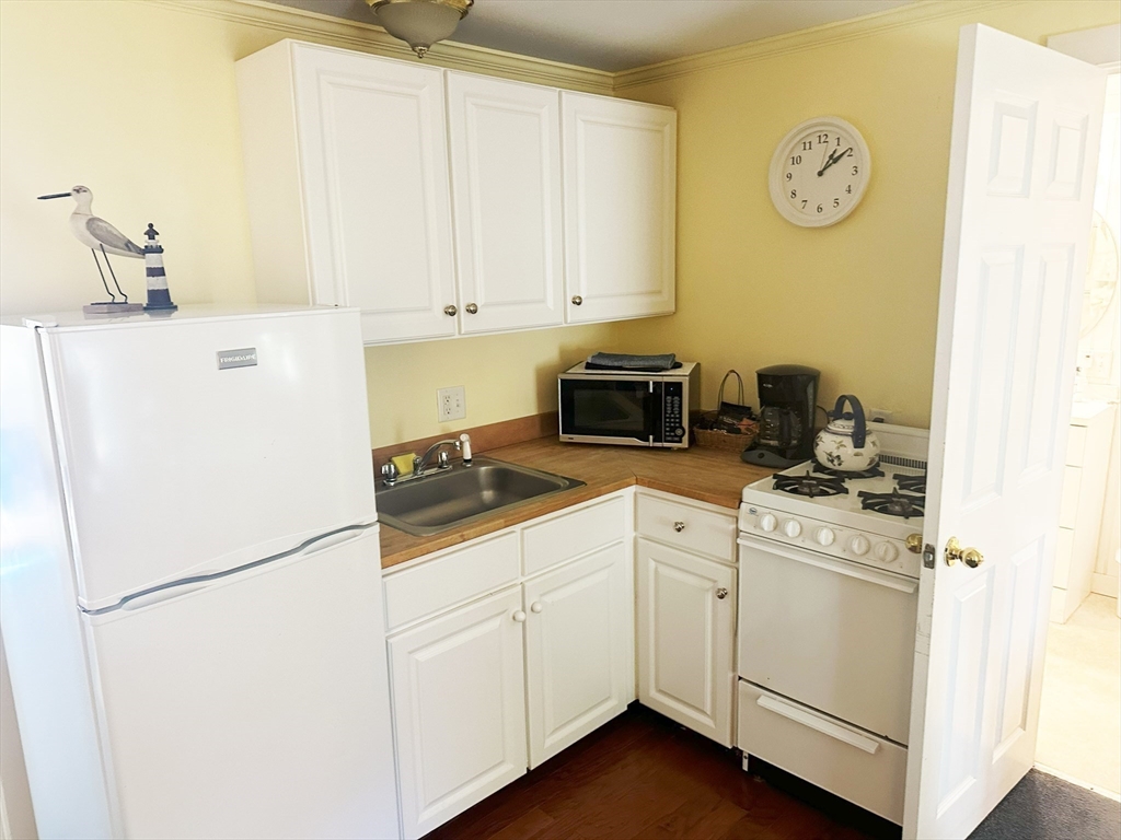 25 Simpson's Lane Edgartown, MA 02539 - Photo 12 of 18 a white refrigerator freezer sitting inside of a kitchen