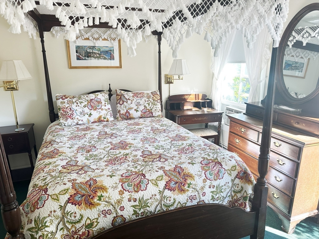 25 Simpson's Lane Edgartown, MA 02539 - Photo 16 of 18 a bedroom with a bed and a mirror on the dresser