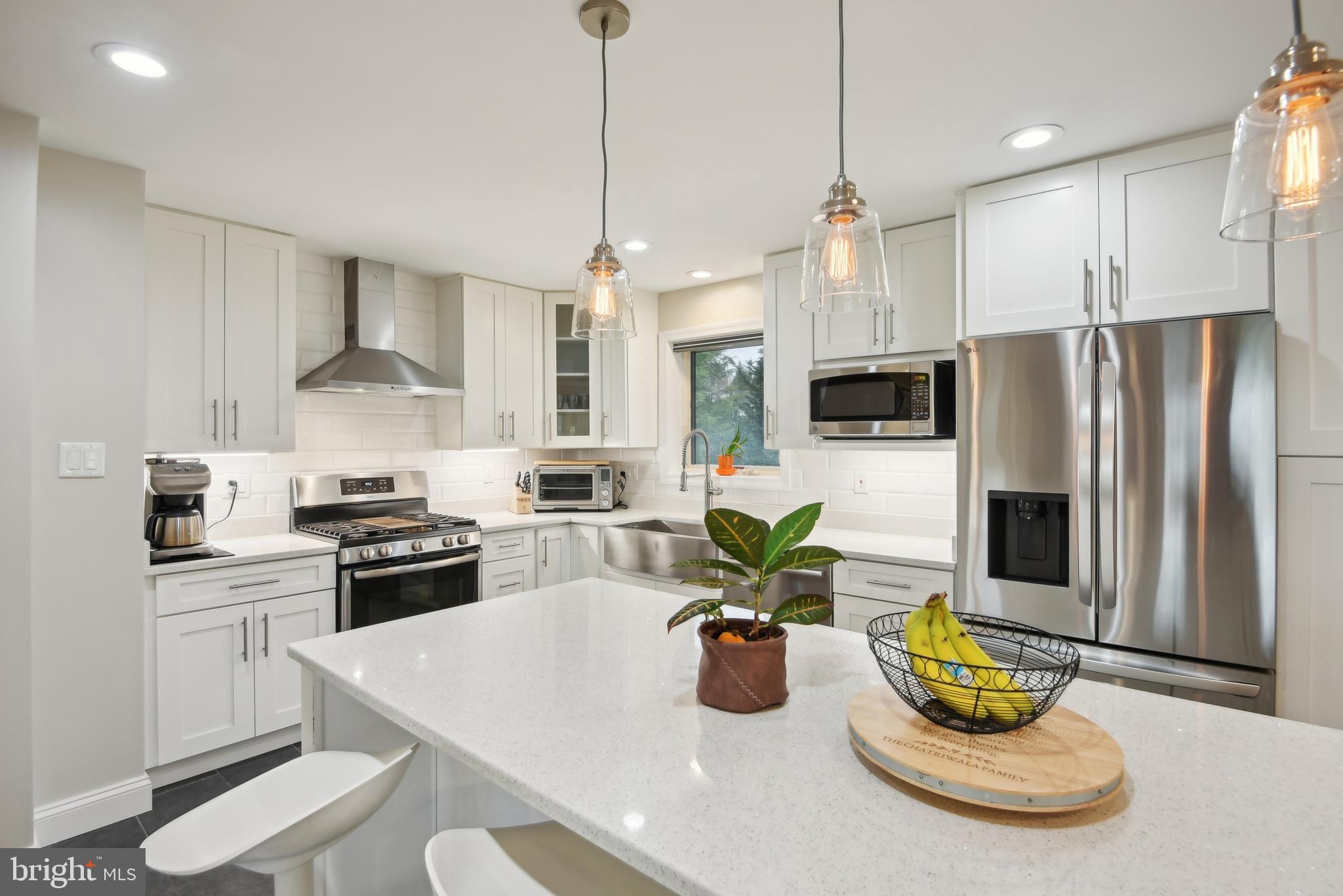 505 Devonshire Drive Northeast Vienna, VA 22180 - Photo 12 of 46 a kitchen with stainless steel appliances a dining table a stove a sink dishwasher a refrigerator with a dining table and chairs