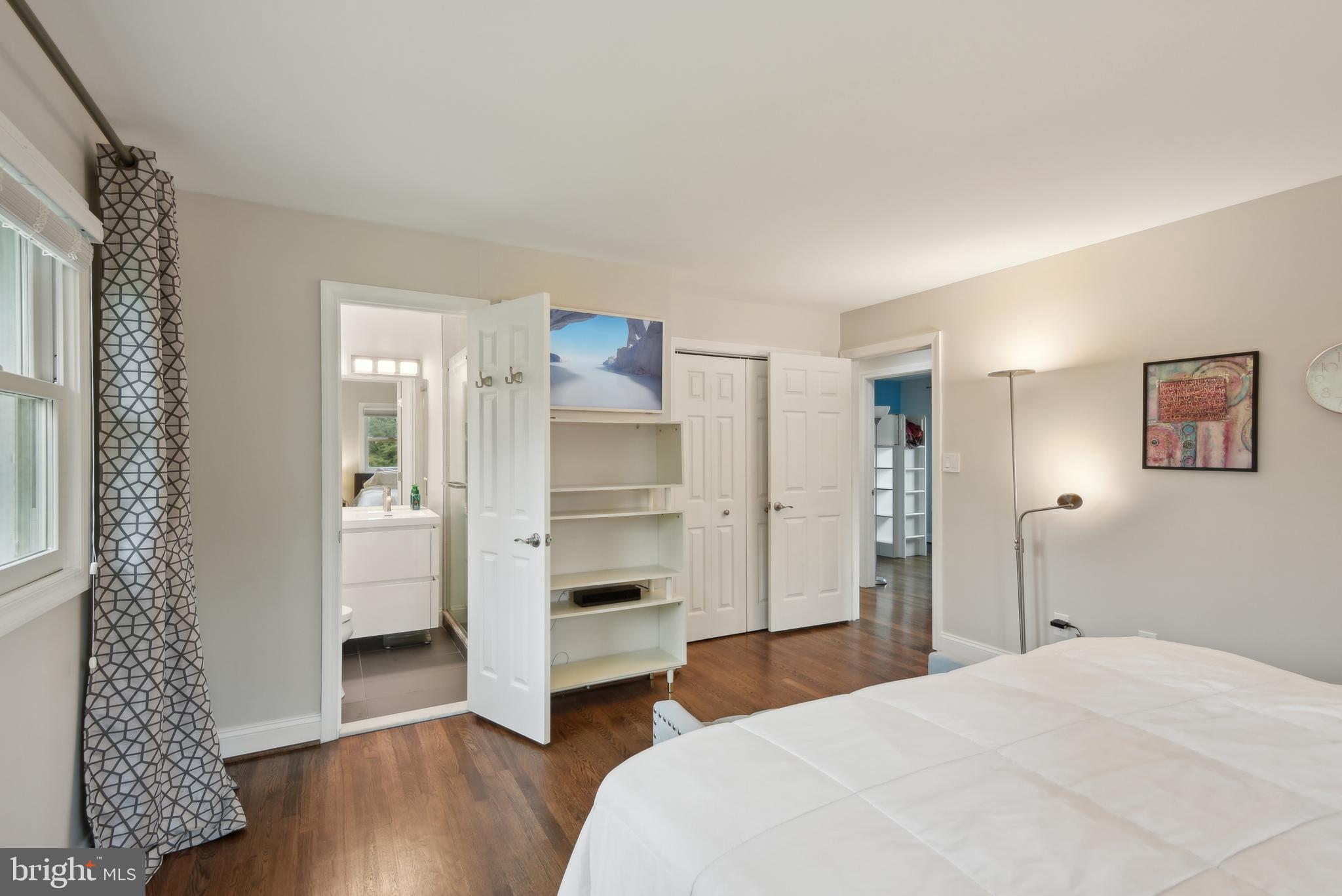 505 Devonshire Drive Northeast Vienna, VA 22180 - Photo 21 of 46 a bedroom with a bed and a view of closet with wooden floor