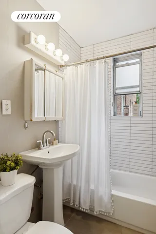 a living room with furniture plant and a window