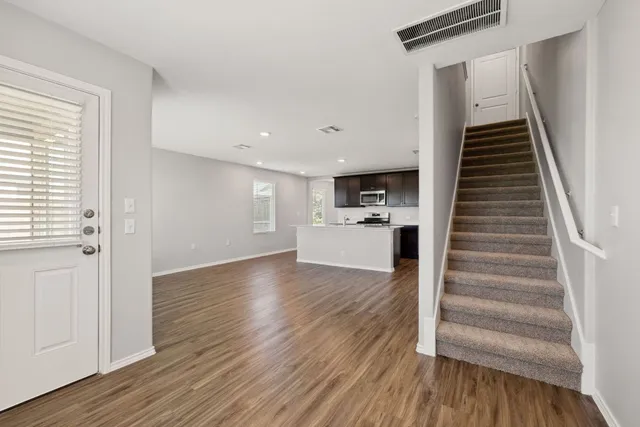 a view of a room with wooden floor and stairs