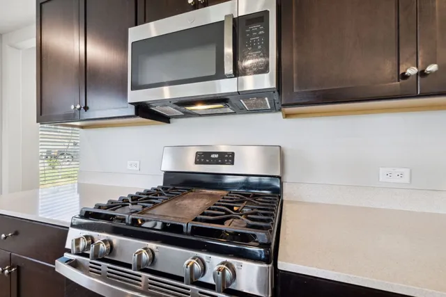 a stove top oven sitting inside of a kitchen