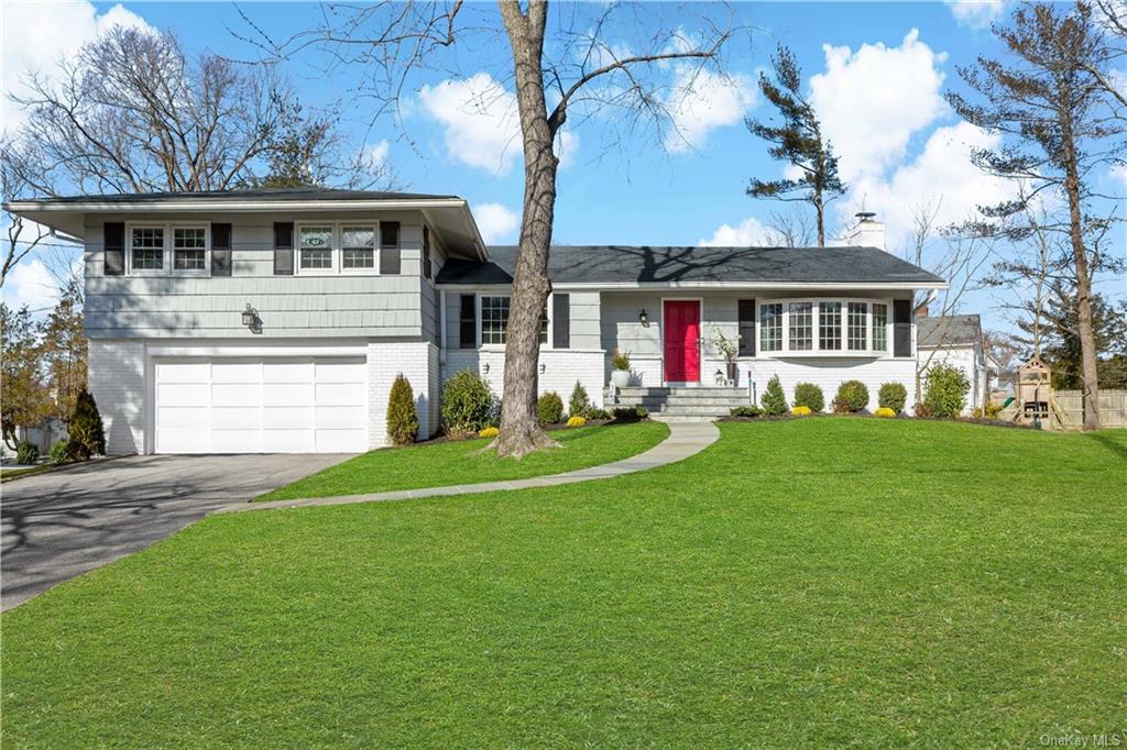 a front view of house with yard and green space