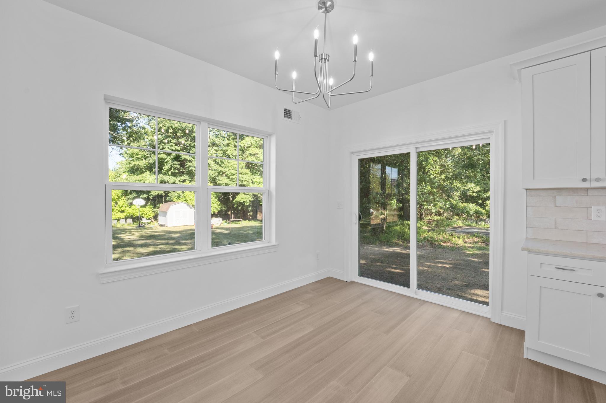 492 Ellis Avenue Lawnside, NJ 08045 - Photo 14 of 33 a view of an empty room with wooden floor and a window