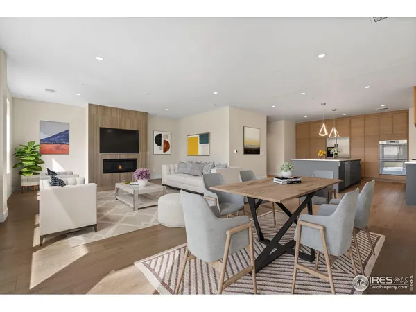 a living room with furniture a flat screen tv and a table