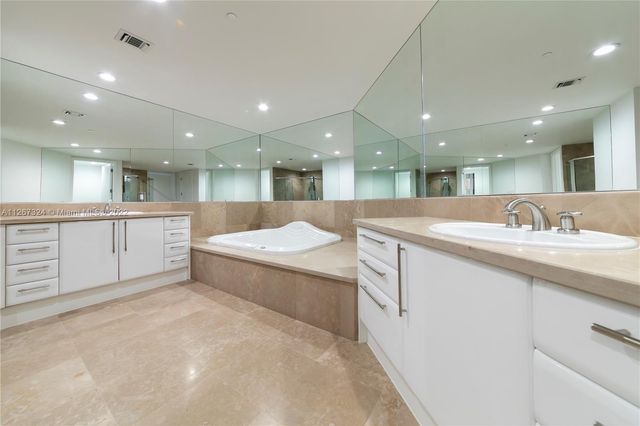 a bathroom with a shower a sink and a mirror