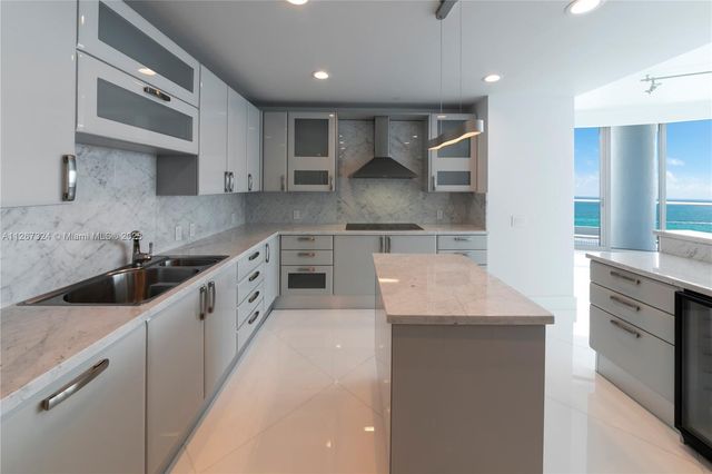 a kitchen with a stove a sink and a refrigerator