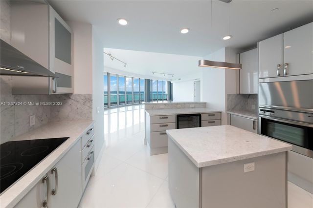 a view of swimming pool with lawn chairs and plants