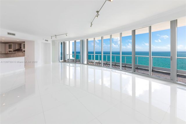 a view of an empty room with windows