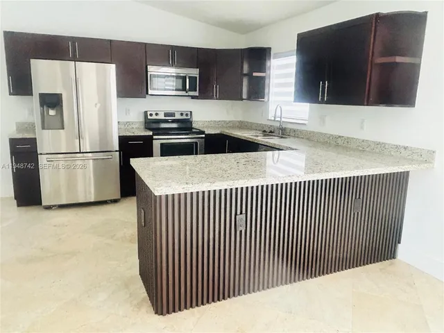 a kitchen with a refrigerator stove and microwave