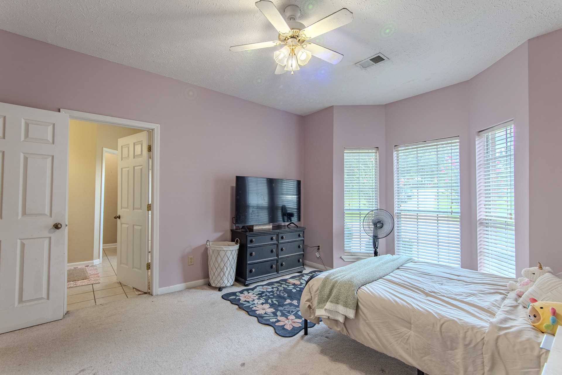 915 Cliffview Road Bolivar, TN 38008 - Photo 42 of 89 a bedroom with a bed and a flat tv screen on dresser