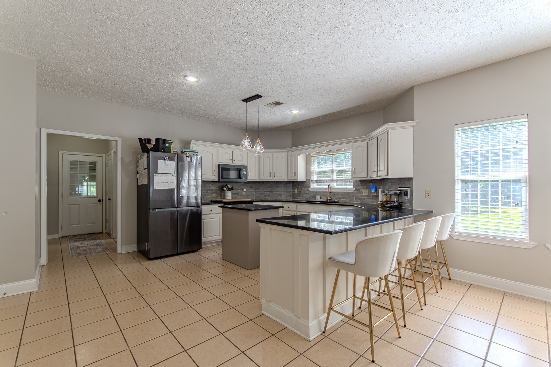 915 Cliffview Road Bolivar, TN 38008 - Photo 75 of 89 a kitchen with stainless steel appliances granite countertop a stove top oven a sink a dining table and chairs