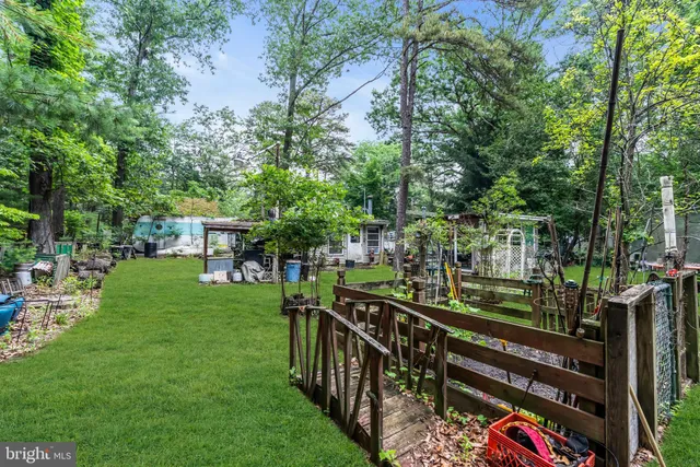 an aerial view of a house with garden space and street view