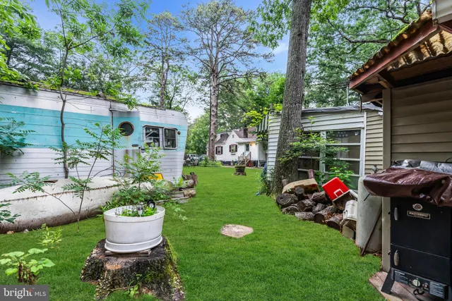 an aerial view of residential houses with outdoor space and trees