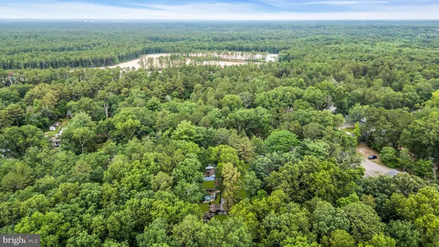 an aerial view of a house with garden space and street view