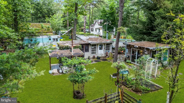 an aerial view of a house with a yard and large trees