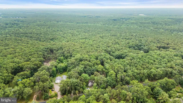 a view of house with backyard space and garden