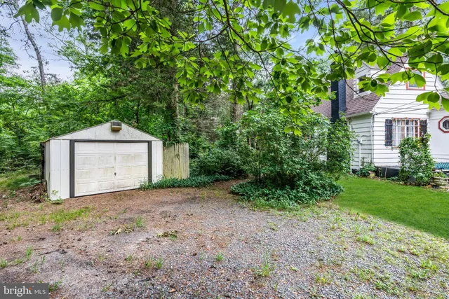 a view of a chair and table in backyard of the house