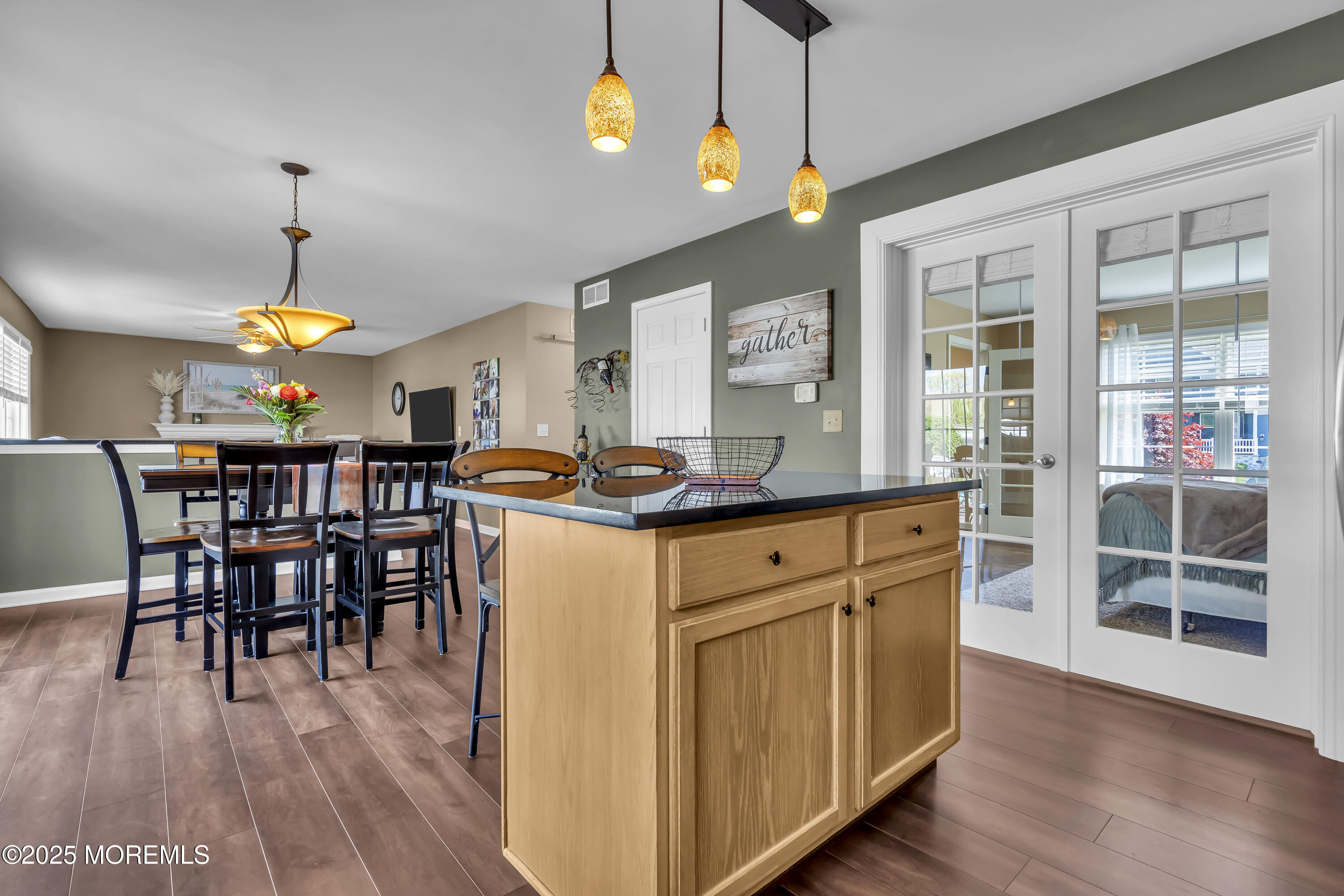 1839 Breakers Drive Manahawkin, NJ 08050 - Photo 23 of 52 a kitchen with stainless steel appliances granite countertop wooden floors and chandelier