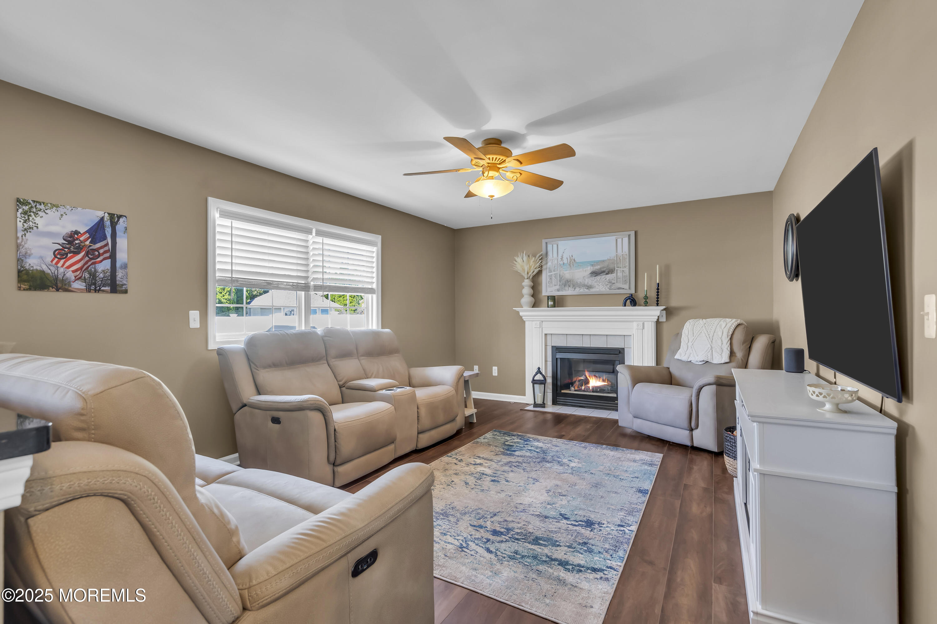 1839 Breakers Drive Manahawkin, NJ 08050 - Photo 26 of 52 a living room with furniture a fireplace and a flat screen tv