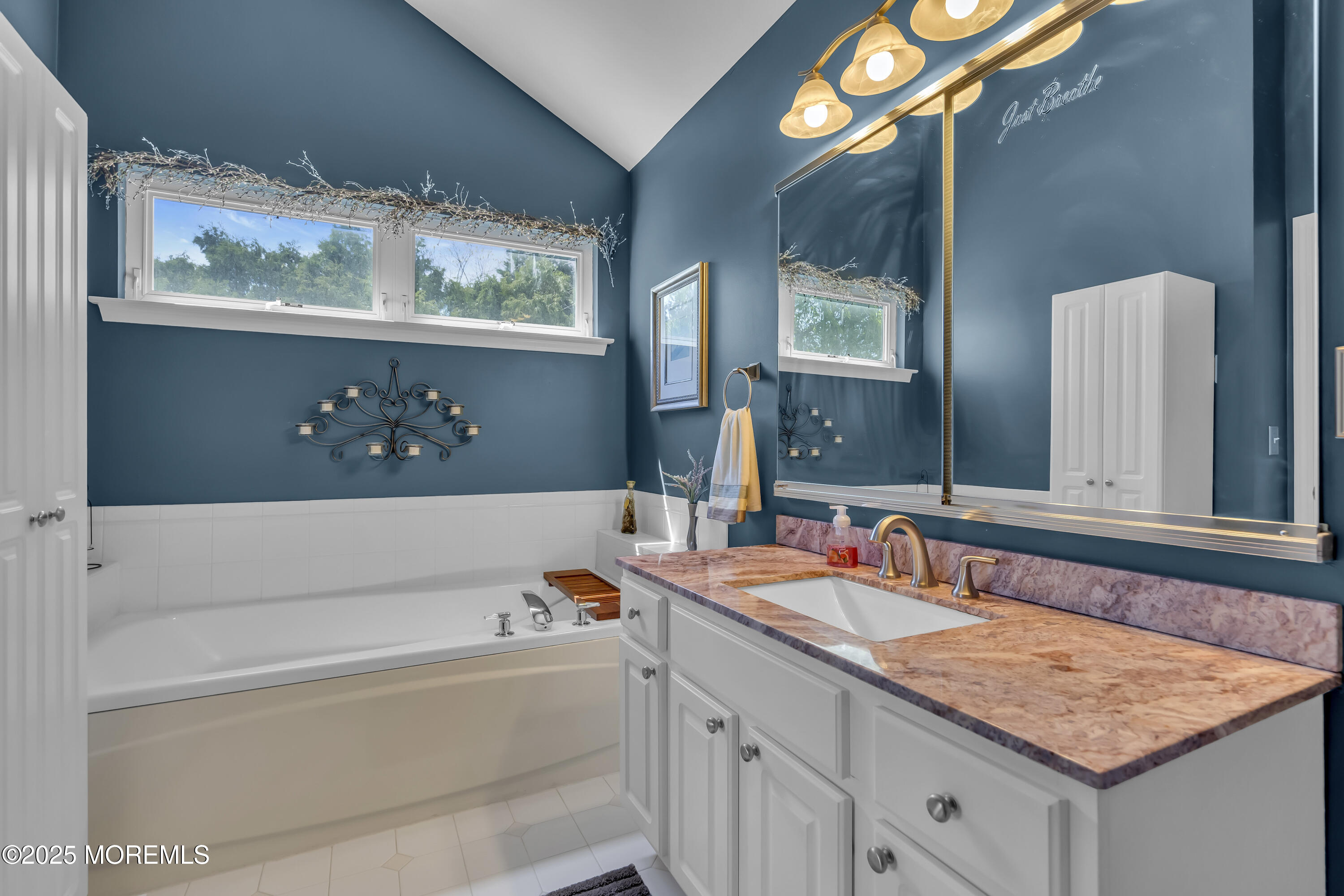 1839 Breakers Drive Manahawkin, NJ 08050 - Photo 34 of 52 a bathroom with a tub a sink and mirror