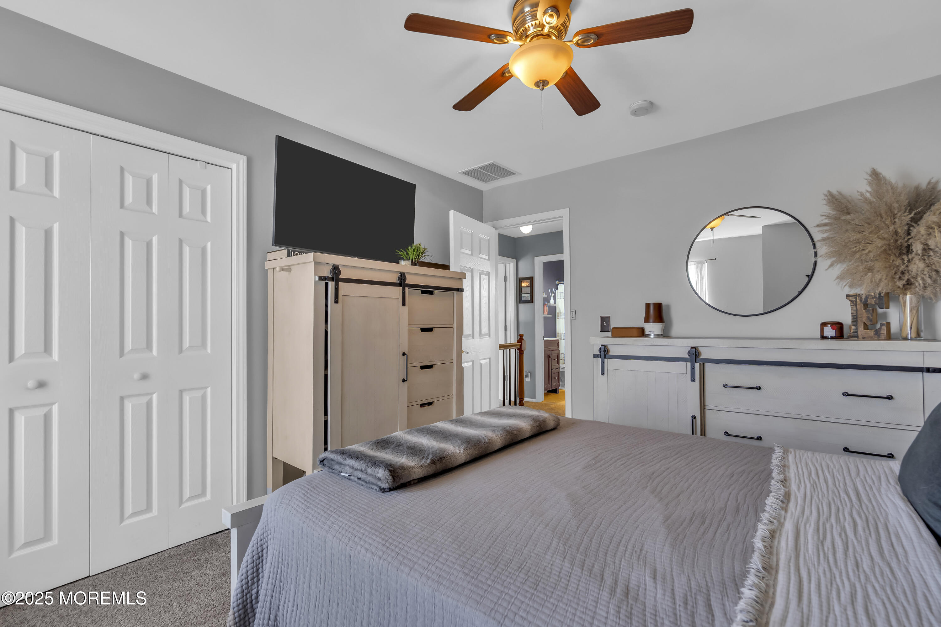 1839 Breakers Drive Manahawkin, NJ 08050 - Photo 37 of 52 a bedroom with a bed and a chandelier