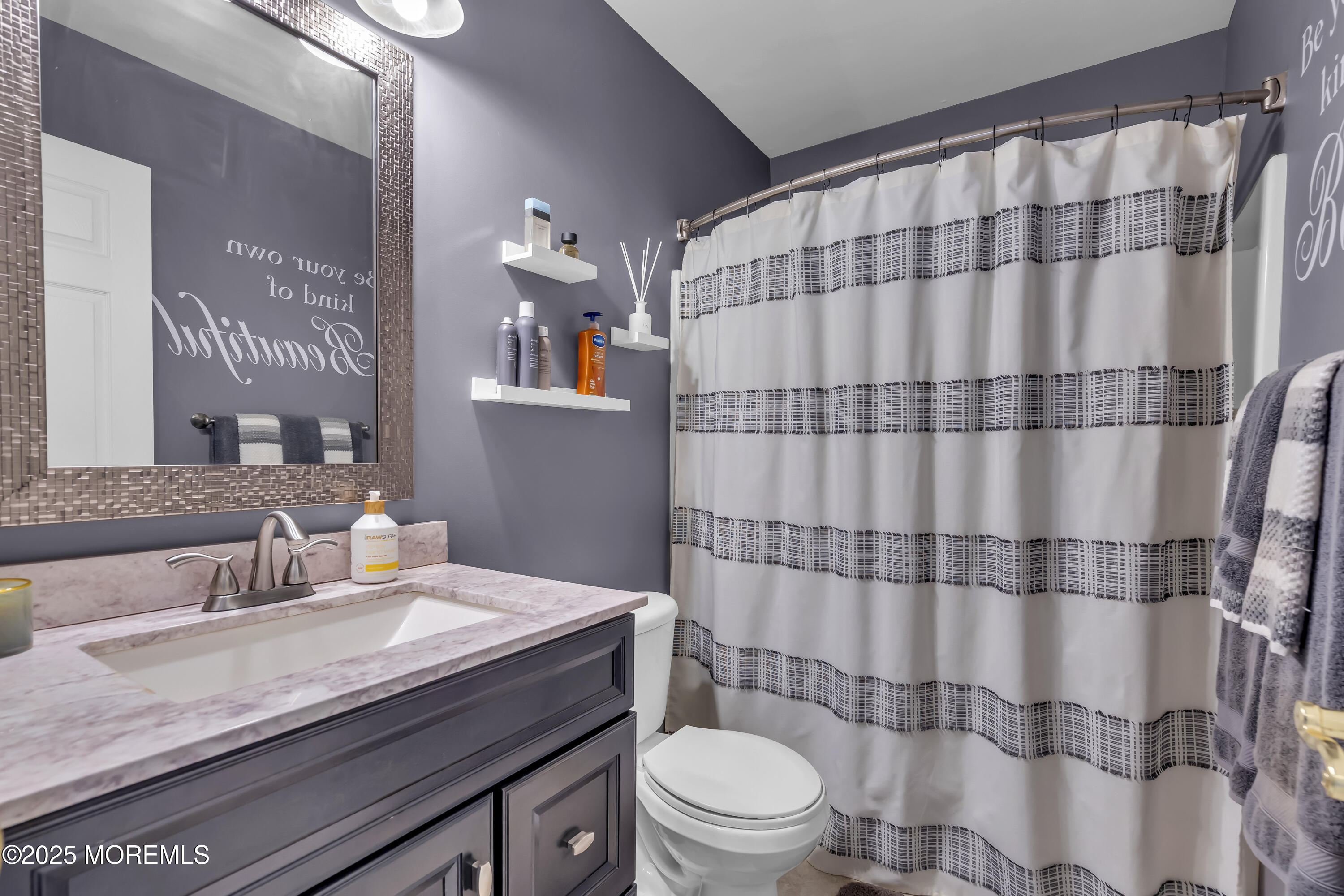 1839 Breakers Drive Manahawkin, NJ 08050 - Photo 41 of 52 a bathroom with a granite countertop bathtub sink vanity mirror and toilet