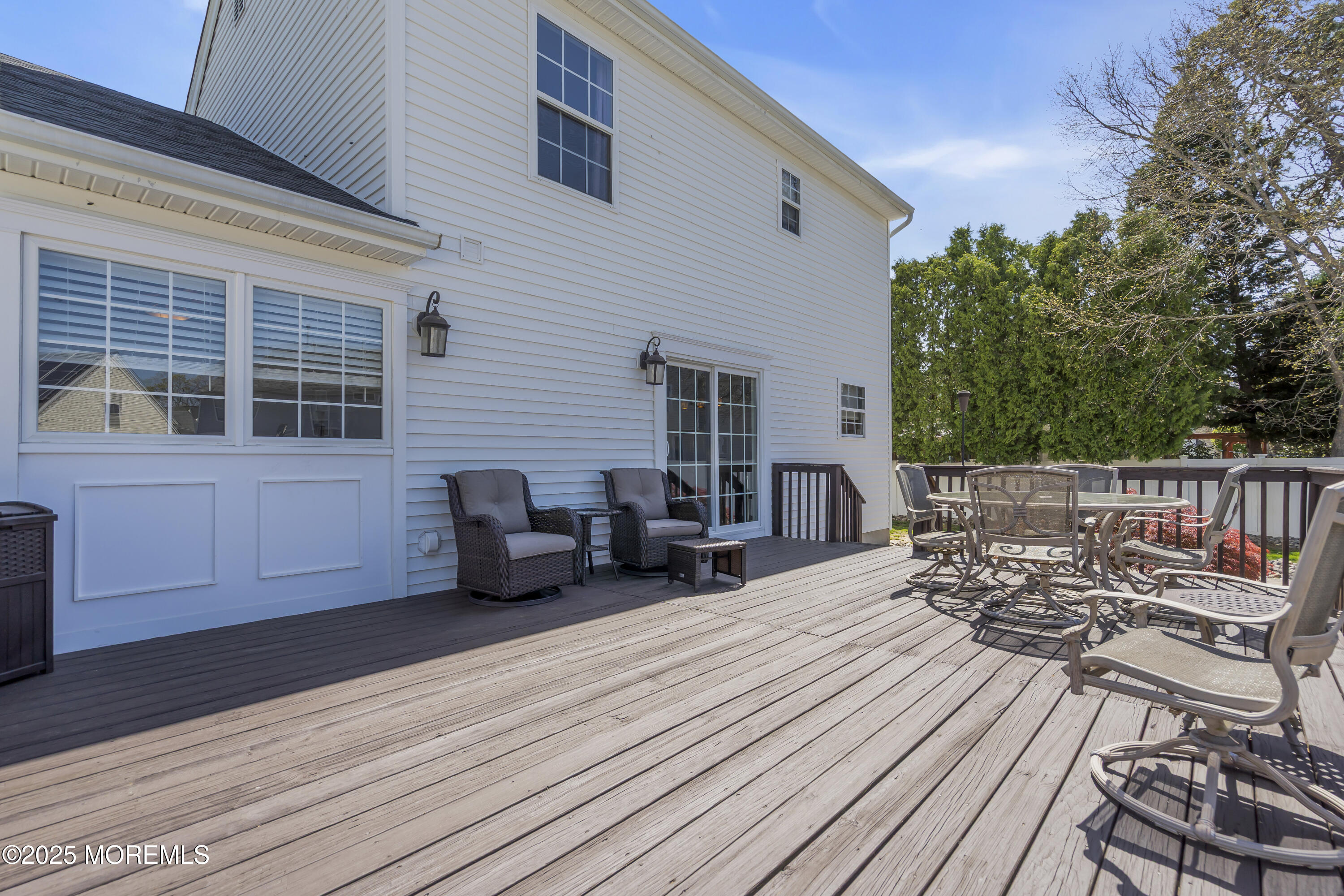 1839 Breakers Drive Manahawkin, NJ 08050 - Photo 44 of 52 a view of a roof deck with table and chairs couches with wooden floor and fence