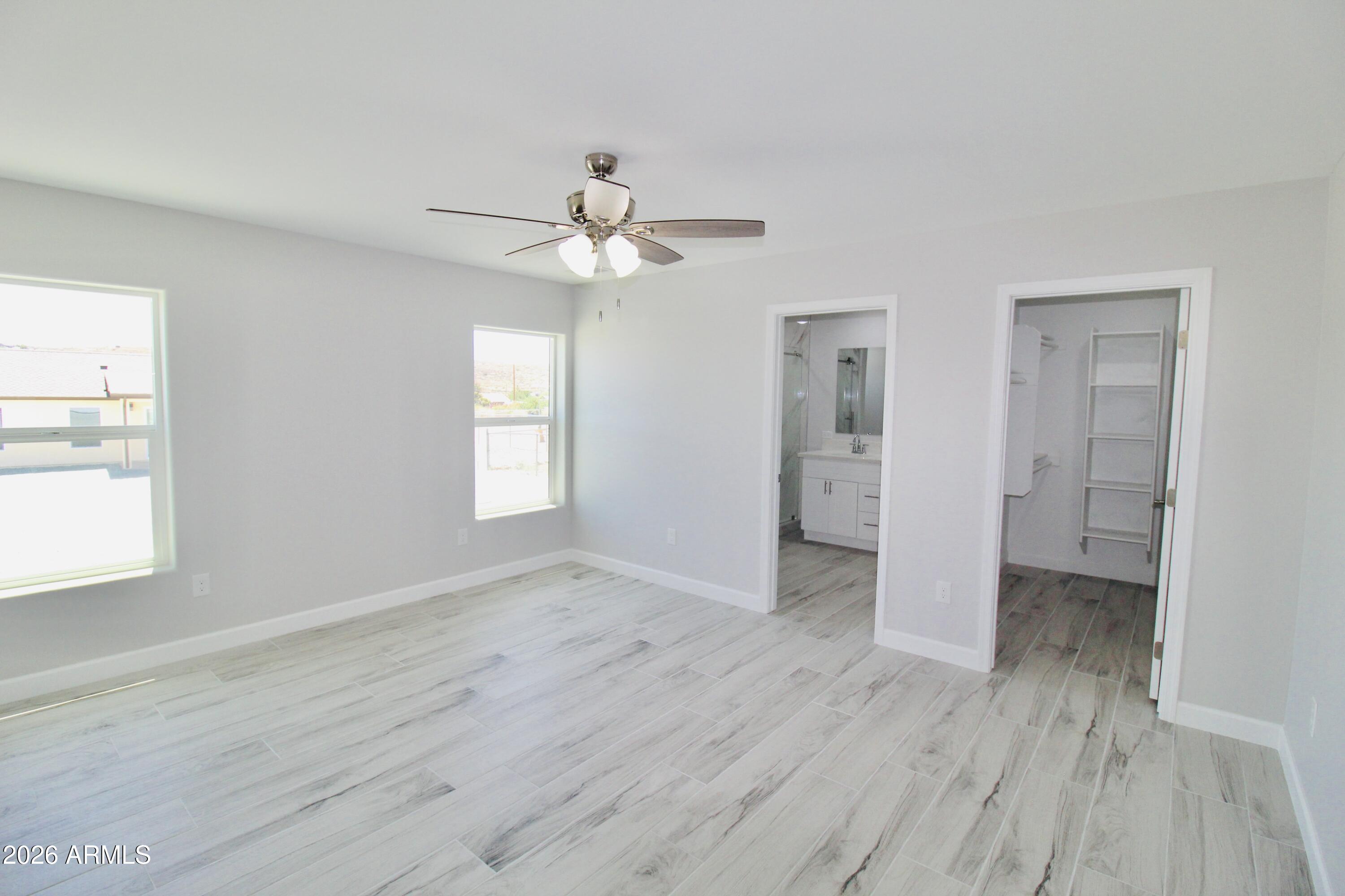 20275 East Mesa Verde Road, Unit 503 Mayer, AZ 86333 - Photo 19 of 32 an empty room with wooden floor and windows