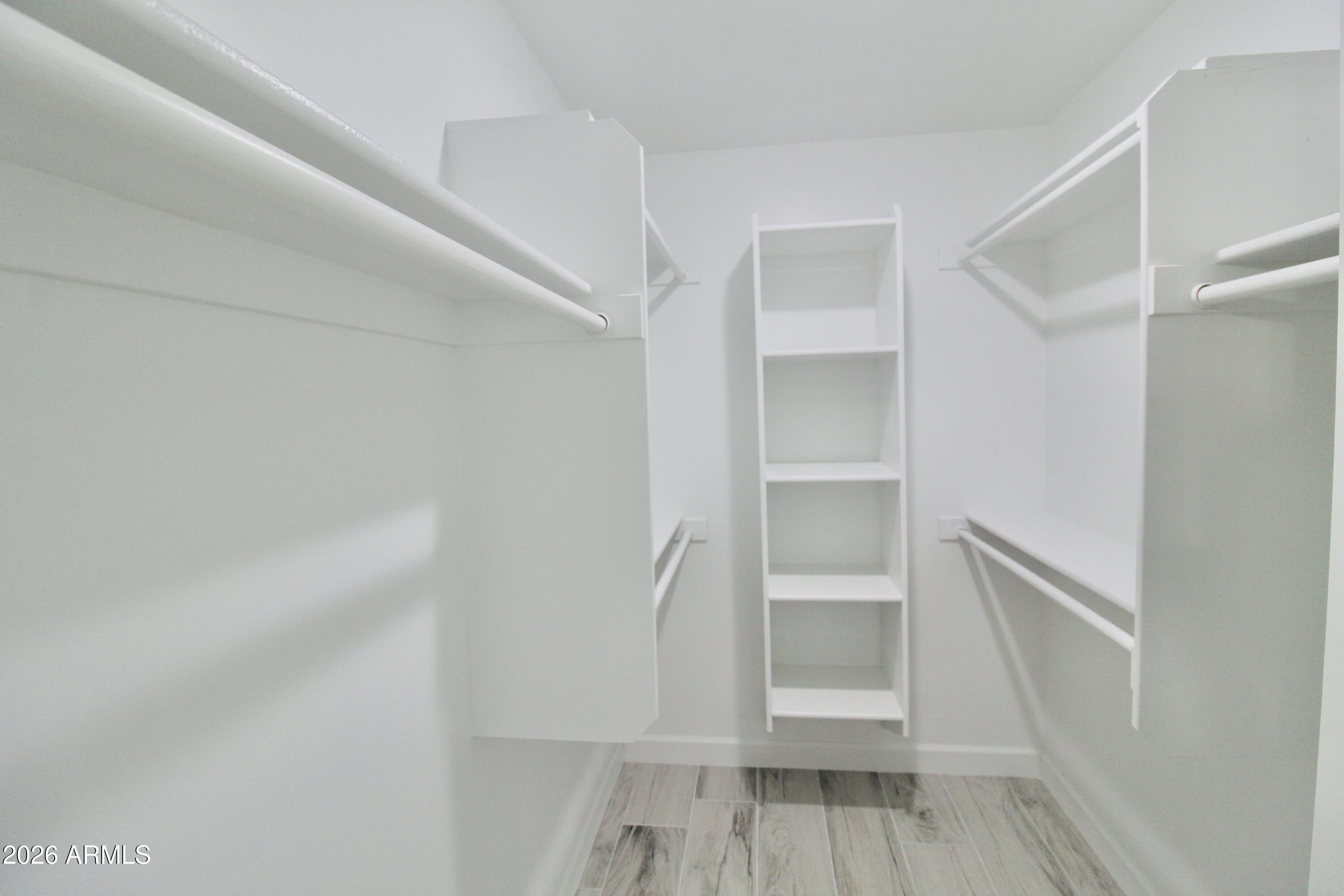 20275 East Mesa Verde Road, Unit 503 Mayer, AZ 86333 - Photo 22 of 32 a view of walk in closet with empty racks