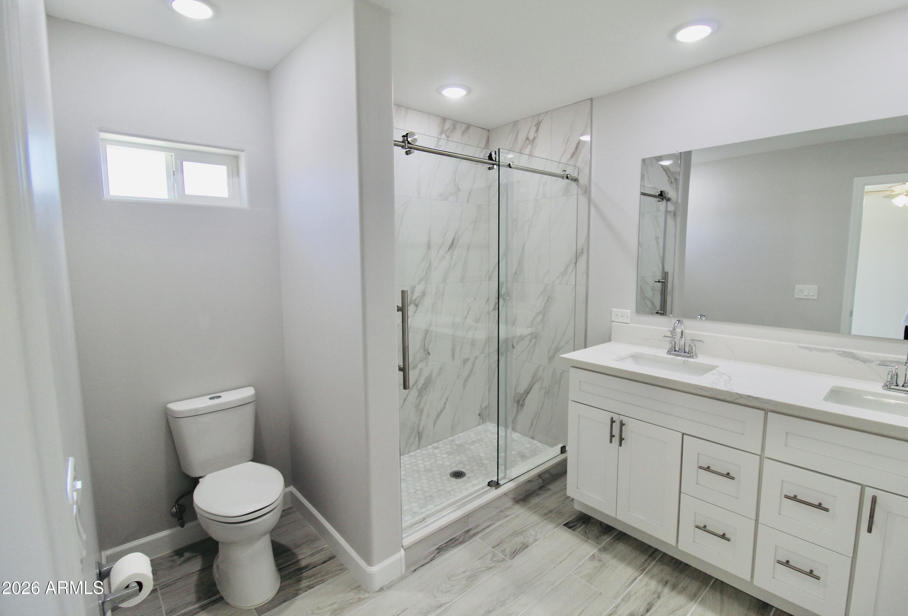 20275 East Mesa Verde Road, Unit 503 Mayer, AZ 86333 - Photo 23 of 32 a bathroom with a shower toilet sink and mirror