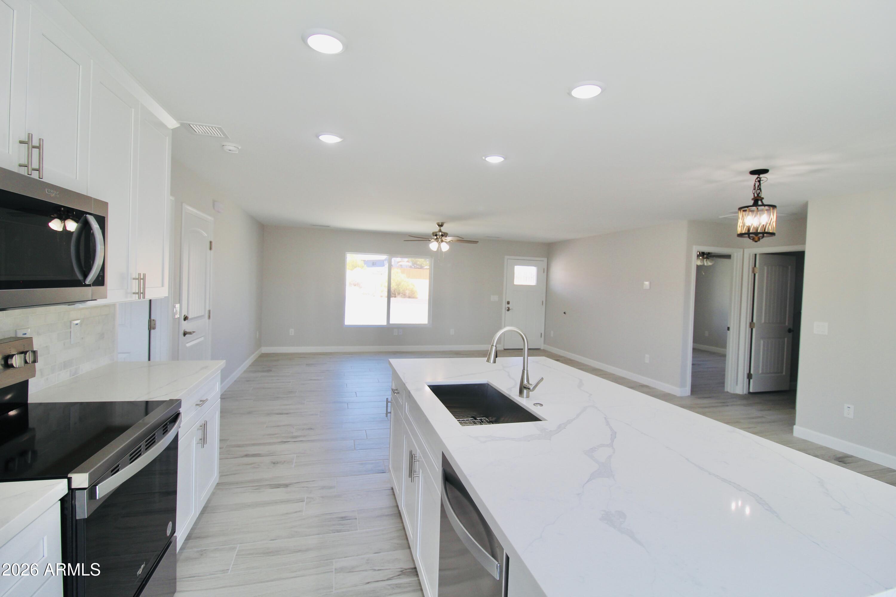 20275 East Mesa Verde Road, Unit 503 Mayer, AZ 86333 - Photo 26 of 32 a kitchen with sink stove and refrigerator