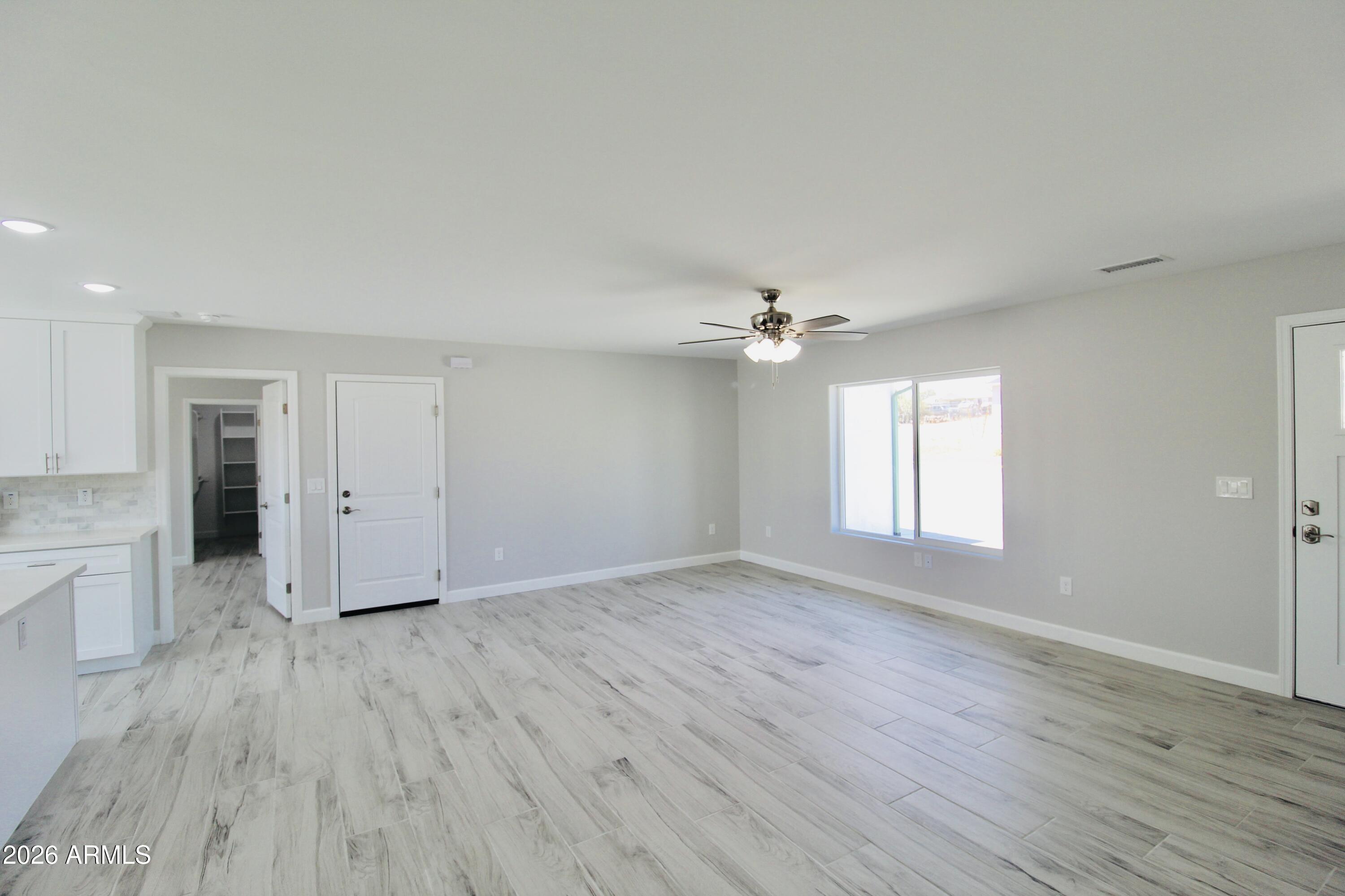 20275 East Mesa Verde Road, Unit 503 Mayer, AZ 86333 - Photo 27 of 32 wooden floor in an empty room with a window