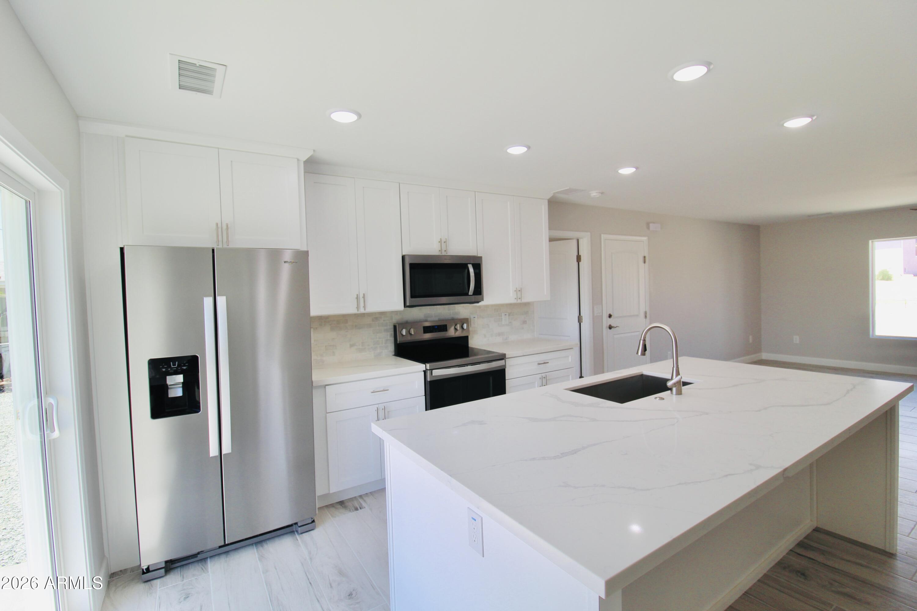 20275 East Mesa Verde Road, Unit 503 Mayer, AZ 86333 - Photo 5 of 32 a kitchen with stainless steel appliances a refrigerator stove microwave and sink