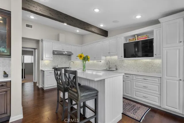 a bathroom with a granite countertop double vanity sink mirror and double