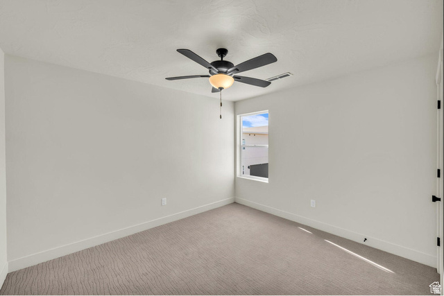 560 Aqua Cove St. George, UT 84790 - Photo 18 of 27 Empty room with carpet floors and a ceiling fan