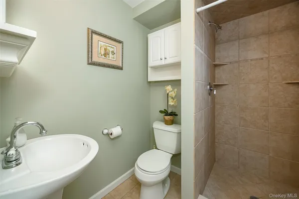 a white toilet sitting next to a bathroom sink