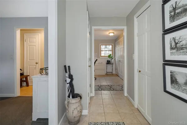 a view of a hallway with bathroom and shower