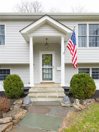 a front view of a house with garden