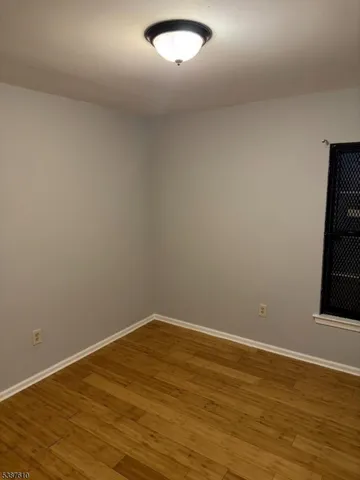 a view of a room with wooden floor and fan