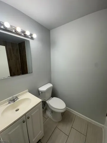 a bathroom with a sink a toilet and mirror