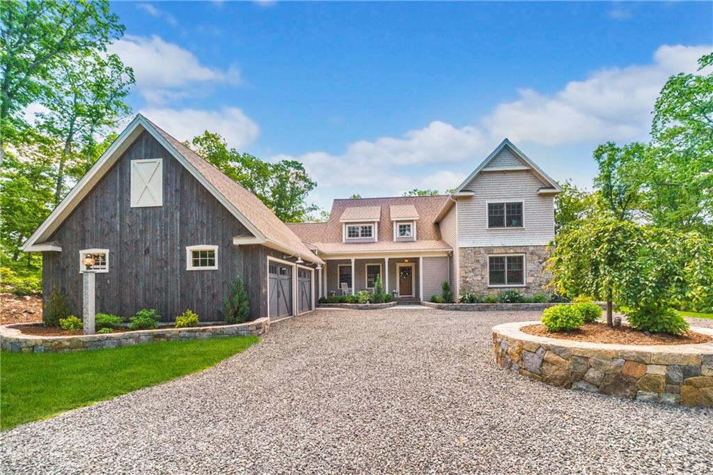 99 Owl Ridge Road Woodbury, CT 06798 - Photo 1 of 1 a front view of a house with a yard and potted plants