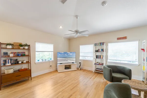a living room with furniture and a wooden floor