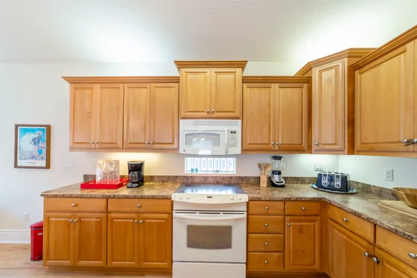 a kitchen with stainless steel appliances granite countertop a sink stove and cabinets