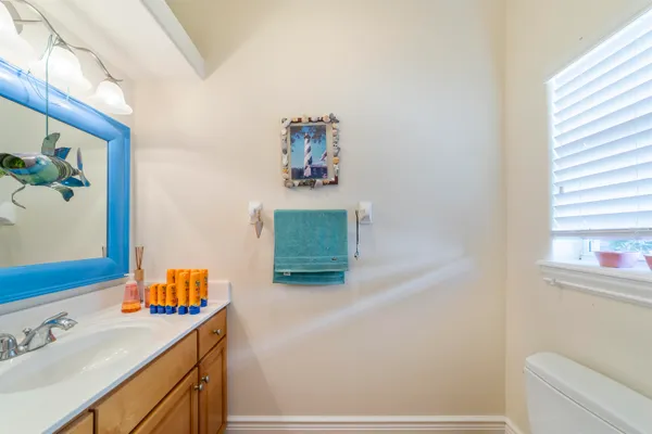 a bathroom with a sink mirror and toilet