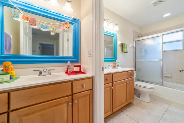 a bathroom with a sink vanity mirror and toilet